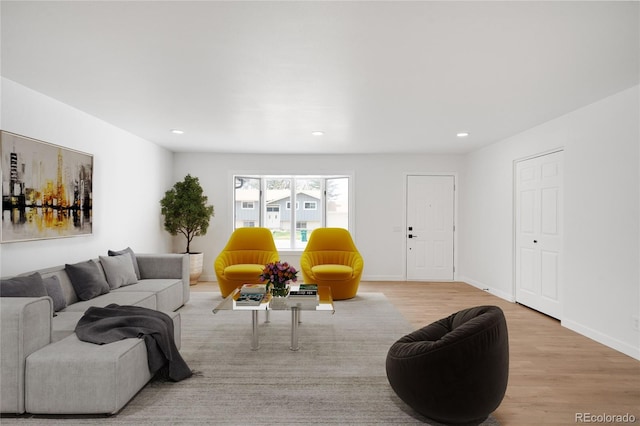 living room featuring recessed lighting, wood finished floors, and baseboards
