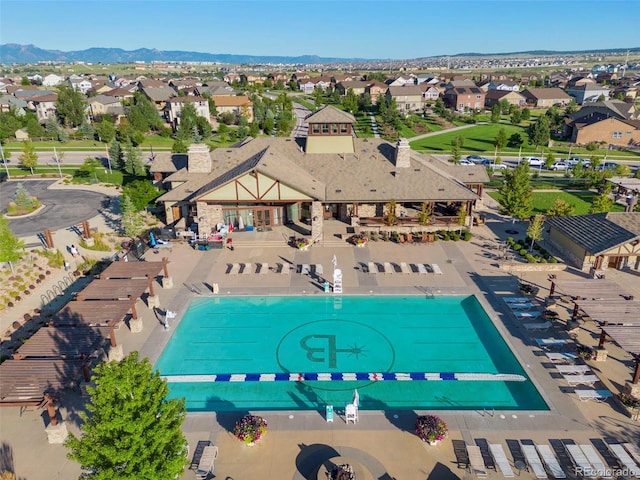 aerial view of residential area featuring a pool area and mountains