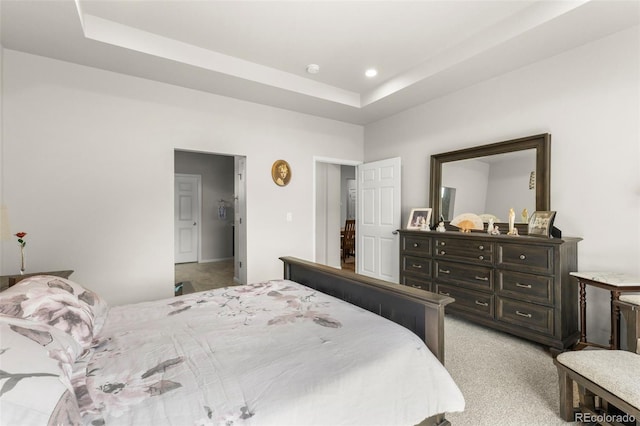 bedroom featuring light colored carpet, a raised ceiling, and recessed lighting