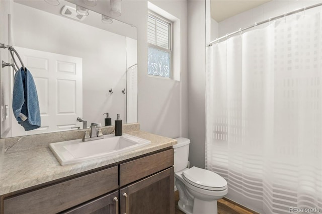 full bathroom with toilet, vanity, and a shower with shower curtain