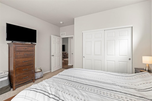 bedroom with light colored carpet, a closet, and baseboards