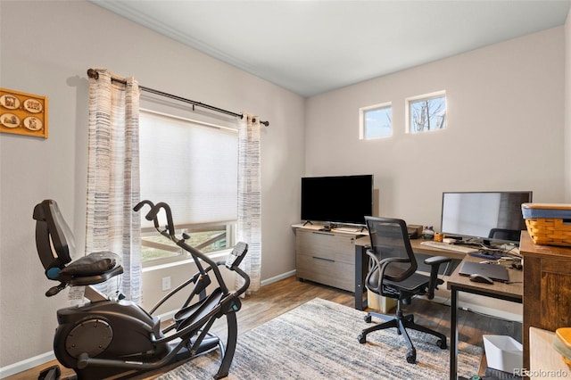 office space with baseboards and wood finished floors