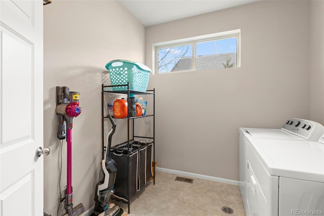 laundry area with washer and clothes dryer and baseboards