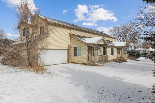 snow covered property featuring a garage