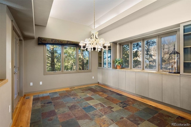 unfurnished dining area featuring a chandelier