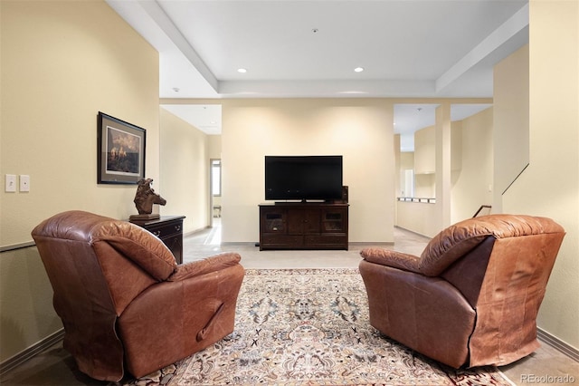 living room featuring a raised ceiling