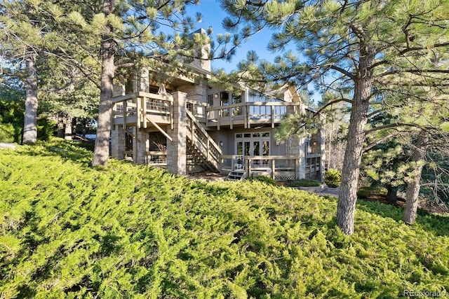 rear view of property featuring a wooden deck