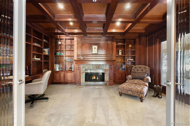 home office featuring carpet floors, wooden walls, built in features, and coffered ceiling