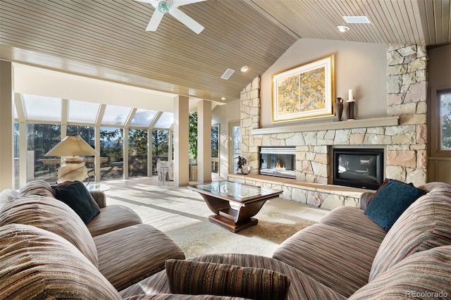 living room with lofted ceiling, a sunroom, wood ceiling, and a stone fireplace