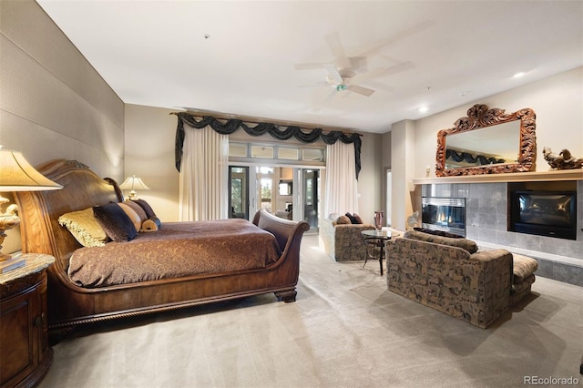 bedroom with ceiling fan, carpet floors, a fireplace, and access to exterior