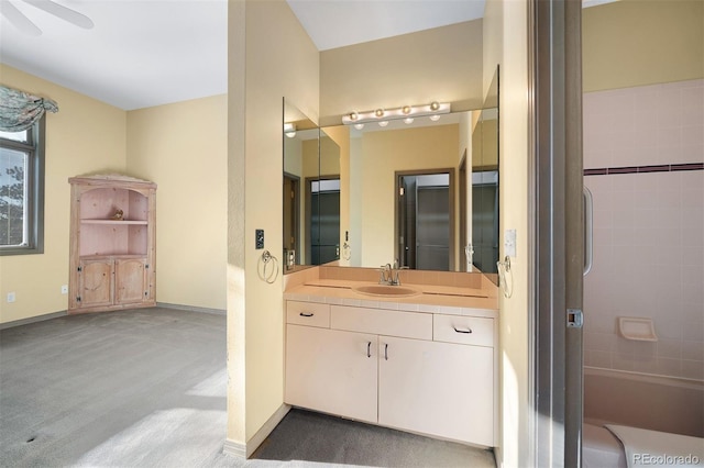 bathroom with ceiling fan, baseboards, a shower, and vanity