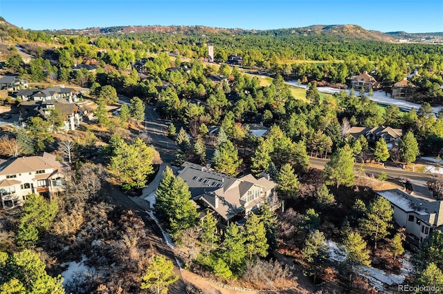 bird's eye view featuring a forest view and a residential view