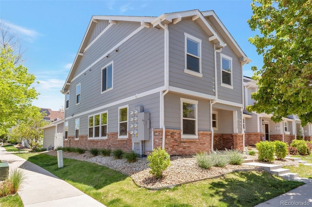 5798 Biscay St, Denver, CO 80249 - view of side of home featuring brick siding and a yard