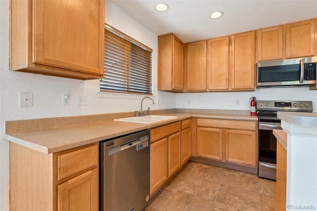 5798 Biscay St, Denver, CO 80249 - kitchen with stainless steel appliances, a sink, recessed lighting, light countertops, and light brown cabinetry