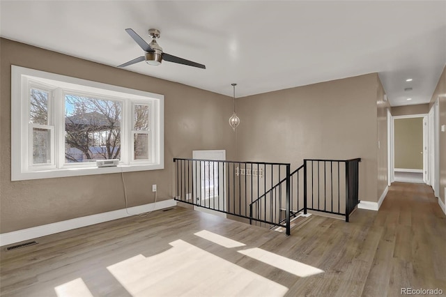 spare room featuring light hardwood / wood-style flooring and ceiling fan