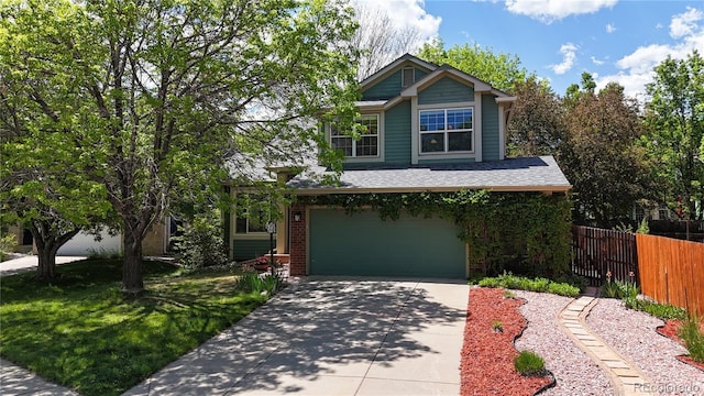 view of front of property with fence, a garage, and concrete driveway