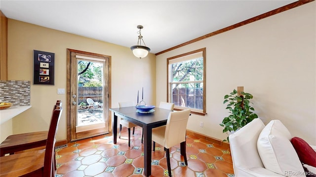 dining space featuring baseboards and ornamental molding