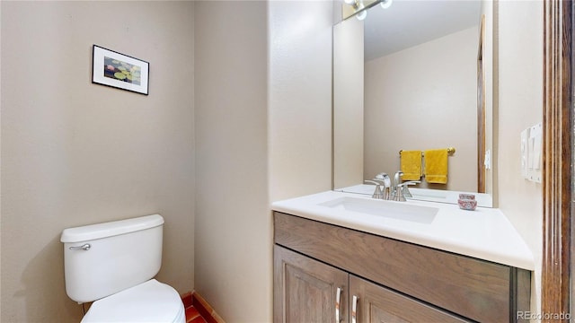 half bathroom featuring toilet and vanity