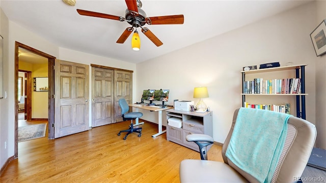 office space with wood finished floors, ceiling fan, and baseboards