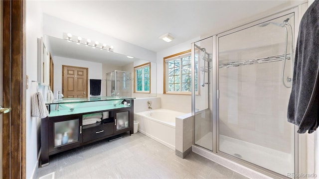 full bath featuring a shower stall, a bath, and vanity
