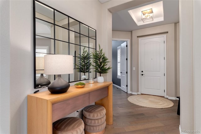 entrance foyer featuring wood finished floors and baseboards