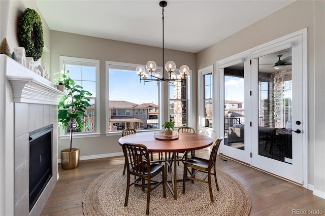 dining room featuring plenty of natural light, a fireplace, and hardwood / wood-style flooring