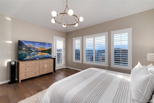 bedroom with dark wood-style floors, access to exterior, baseboards, and an inviting chandelier