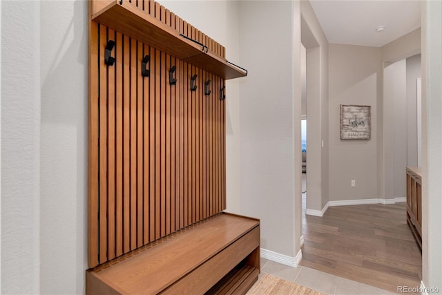 mudroom featuring light tile patterned floors and baseboards