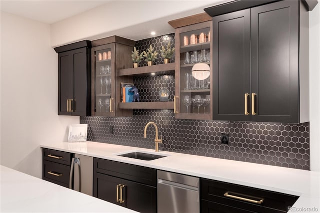 kitchen with light countertops, tasteful backsplash, and a sink