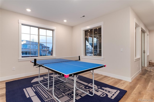 rec room featuring recessed lighting, wood finished floors, visible vents, and baseboards