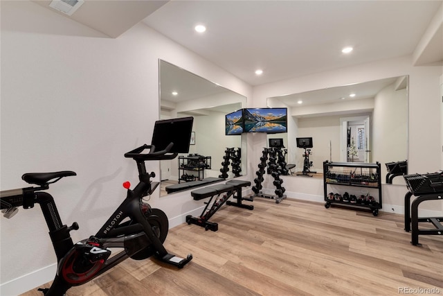 exercise room featuring baseboards, visible vents, wood finished floors, and recessed lighting