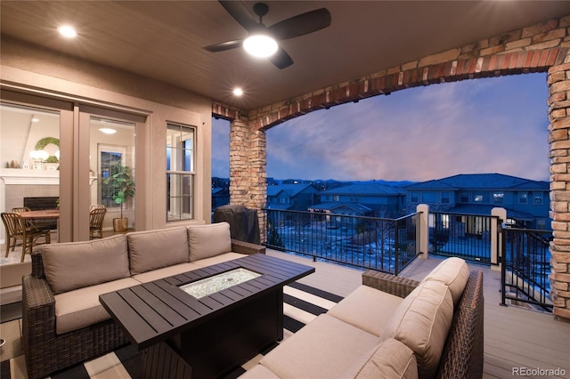 view of patio with an outdoor living space with a fire pit and a ceiling fan