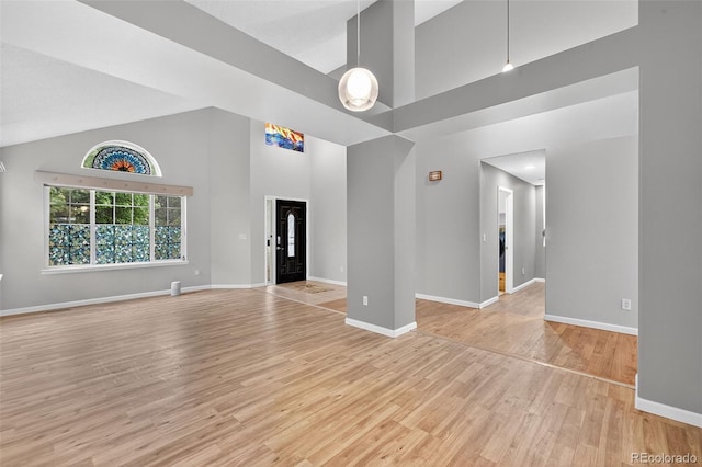 7330 Cotton Dr, Colorado Springs, CO 80923 - unfurnished room featuring high vaulted ceiling, light wood-style floors, and baseboards