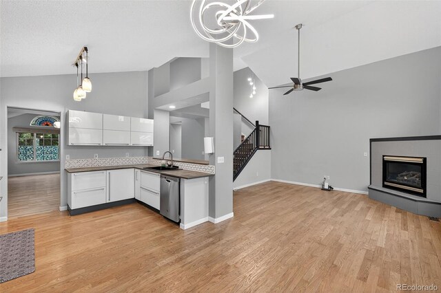 7330 Cotton Dr, Colorado Springs, CO 80923 - kitchen with dishwasher, high vaulted ceiling, white cabinets, open floor plan, and ceiling fan