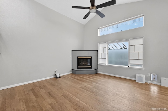 7330 Cotton Dr, Colorado Springs, CO 80923 - unfurnished living room featuring high vaulted ceiling, ceiling fan, wood finished floors, a fireplace, and baseboards