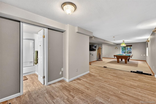 7330 Cotton Dr, Colorado Springs, CO 80923 - game room featuring billiards table, light wood-style floors, baseboards, and a textured ceiling