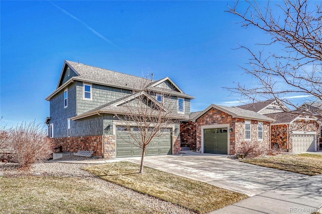 view of front of home featuring stone siding, an attached garage, driveway, and a shingled roof