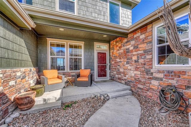 entrance to property featuring stone siding and covered porch