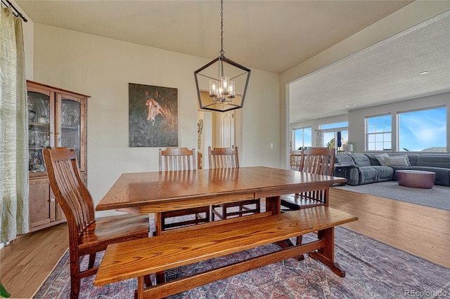 dining space featuring a chandelier and wood finished floors