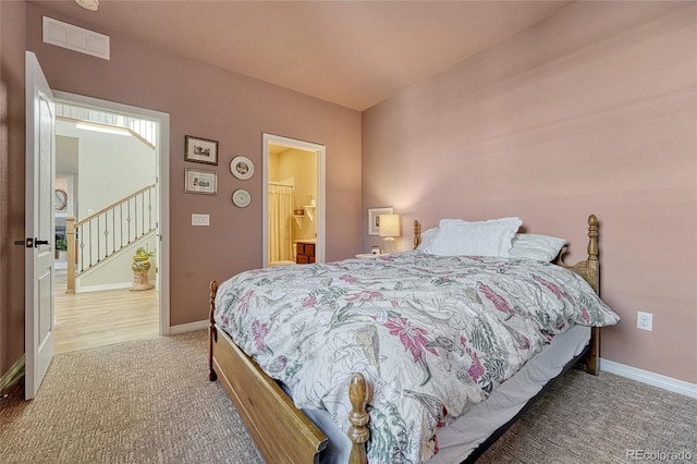 bedroom featuring visible vents, baseboards, and carpet