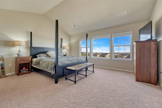 carpeted bedroom with vaulted ceiling, baseboards, and visible vents