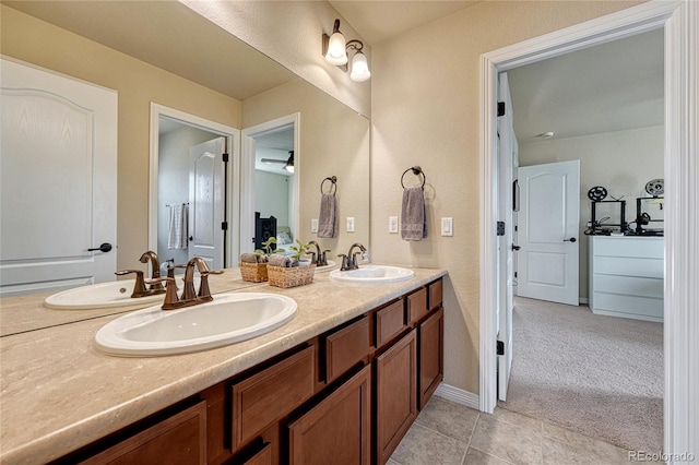 full bathroom with a sink, double vanity, and tile patterned flooring