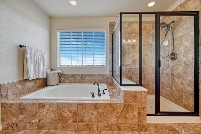 bathroom featuring recessed lighting, a stall shower, and a garden tub