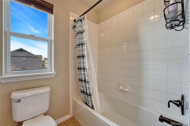 bathroom featuring toilet, shower / tub combo, and tile patterned flooring