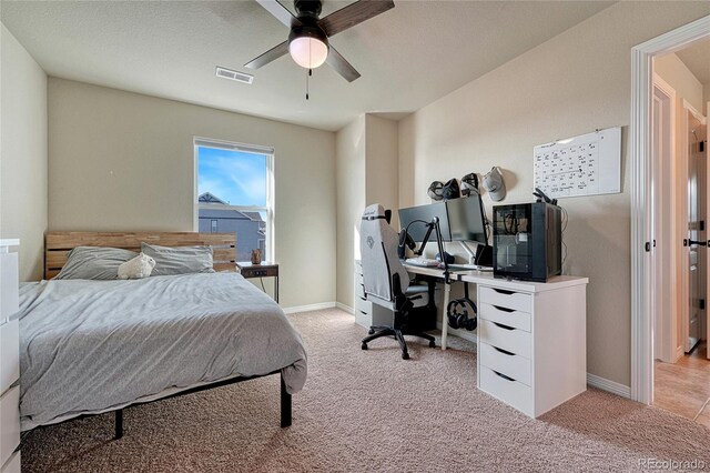 carpeted bedroom featuring baseboards, visible vents, and ceiling fan