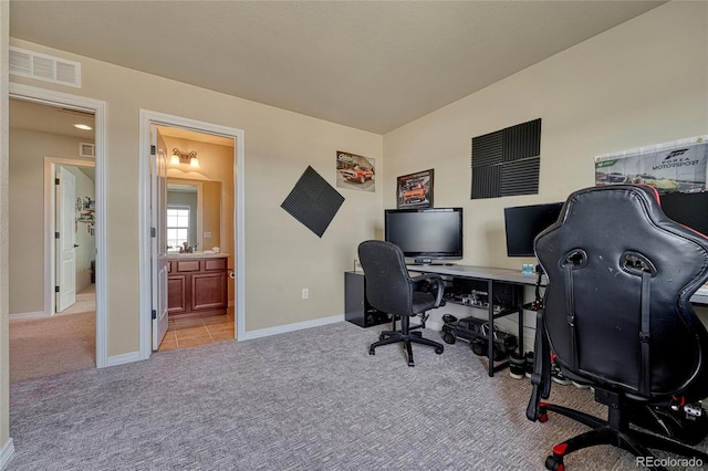 office space with carpet, visible vents, and baseboards