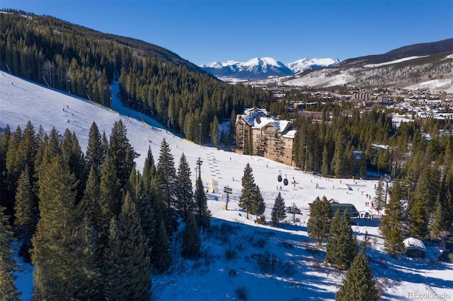 snowy aerial view featuring a mountain view