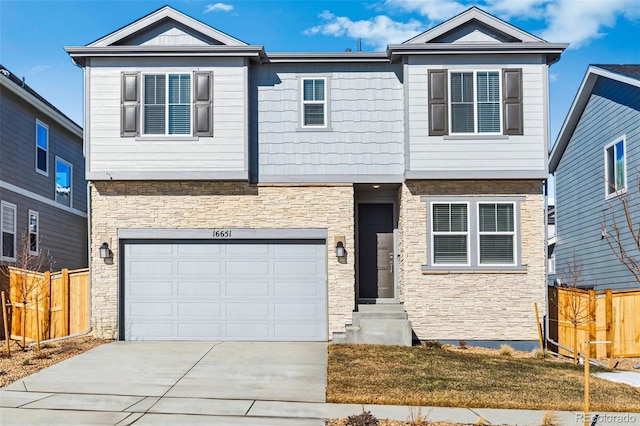 view of front facade with a garage, fence, stone siding, and driveway