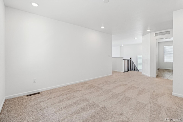 spare room with recessed lighting, visible vents, and carpet floors