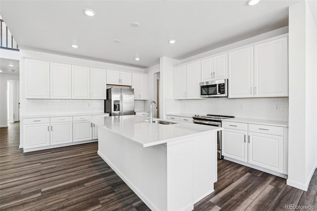 kitchen featuring white cabinets, dark wood-style flooring, appliances with stainless steel finishes, and a sink
